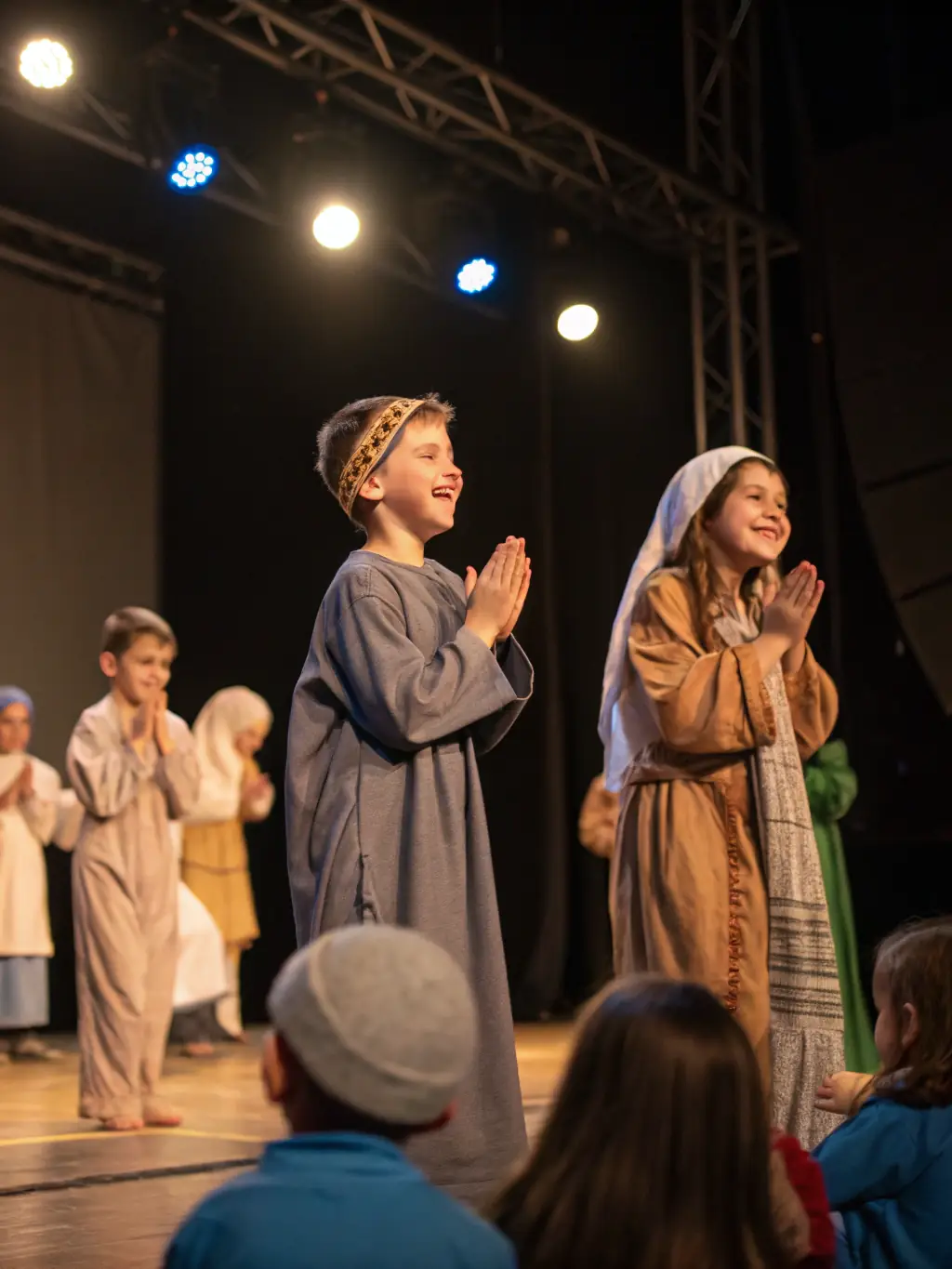A group of children enthusiastically participating in a theater workshop, dressed in costumes and acting out a scene on a small stage.
